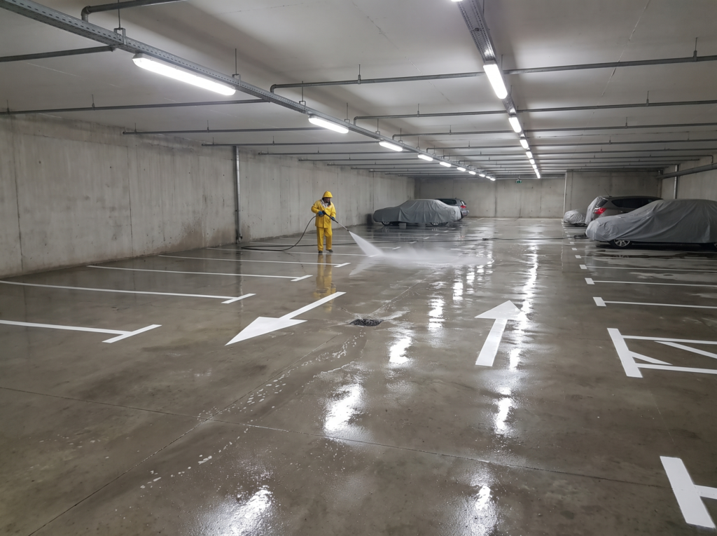 Basement car park pressure cleaned with gleaming floor and crisp line markings