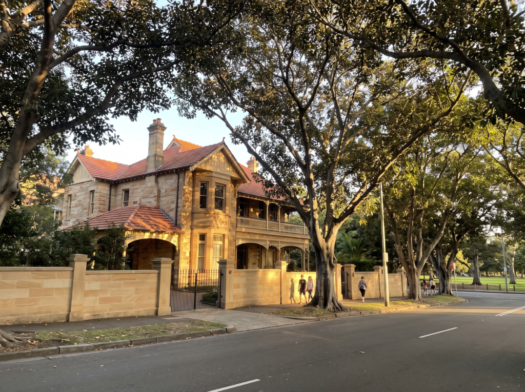 Grand Federation mansion with clean sandstone fence on a tree-lined Centennial Park avenue