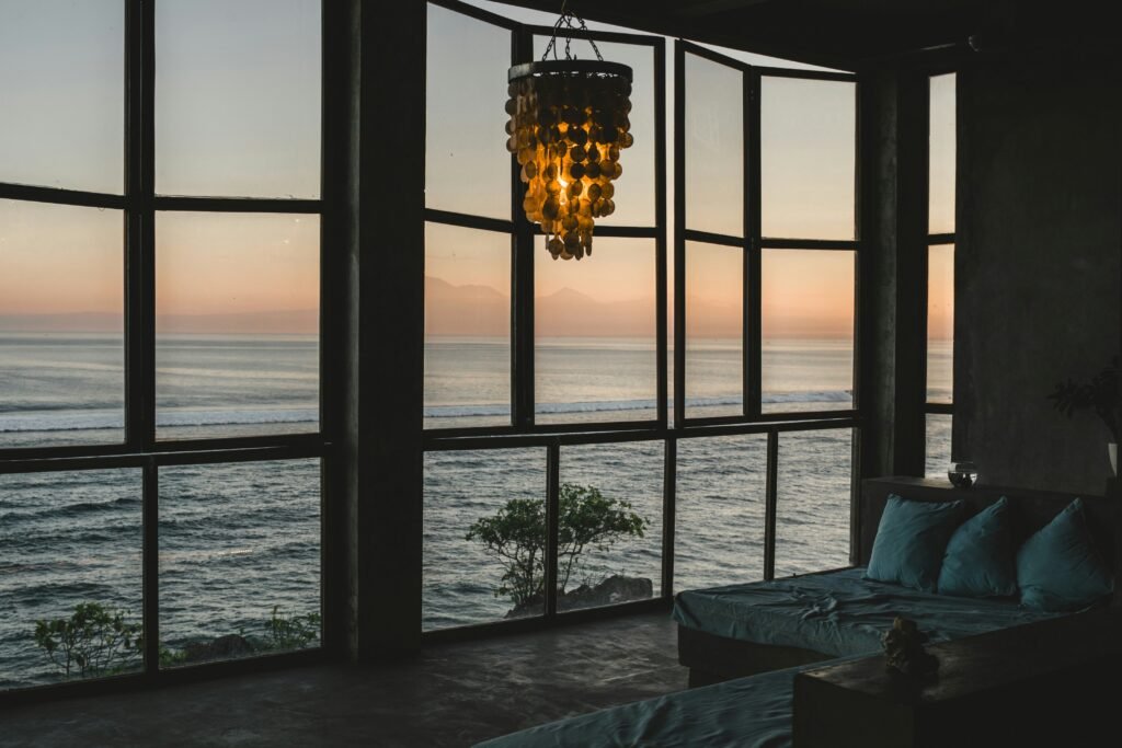 Large coastal windows facing the ocean, exposed to constant salt aerosol
