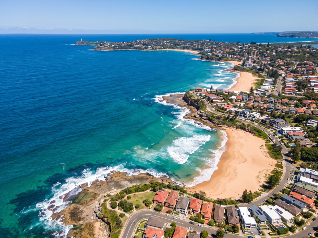 Aerial view of the Northern Beaches peninsula, surf beaches and headlands toward Palm Beach