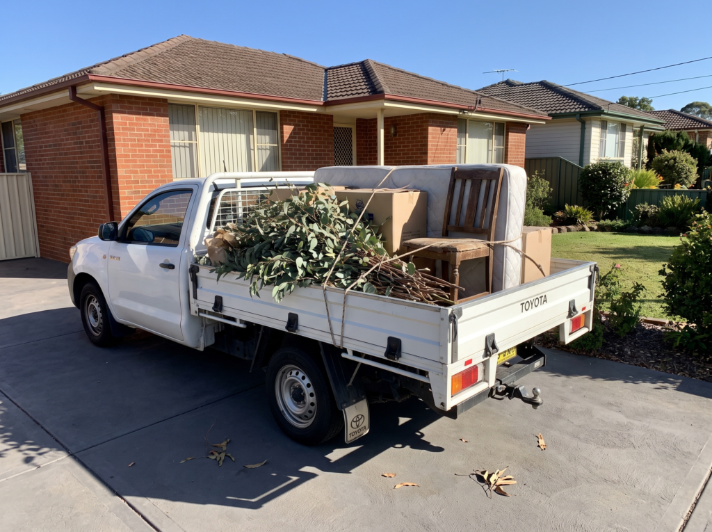 Ute tray loaded neatly with garden waste and furniture for rubbish removal