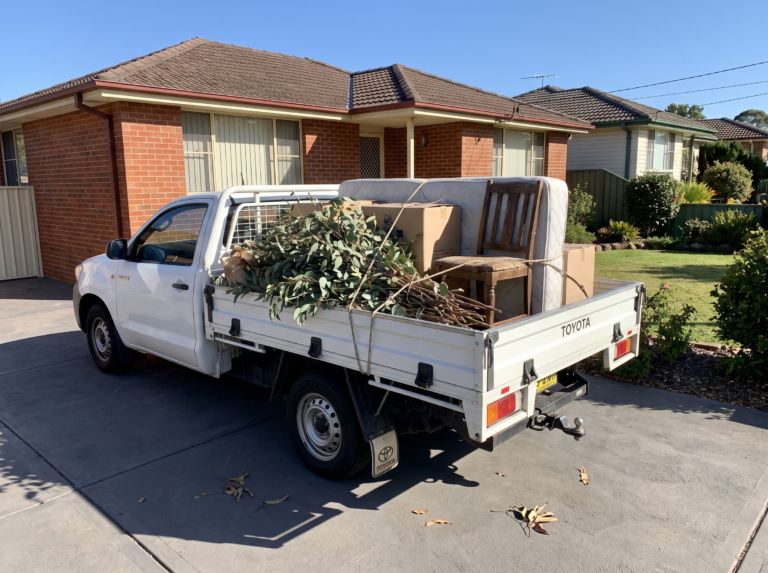 Ute tray loaded neatly with garden waste and furniture for rubbish removal