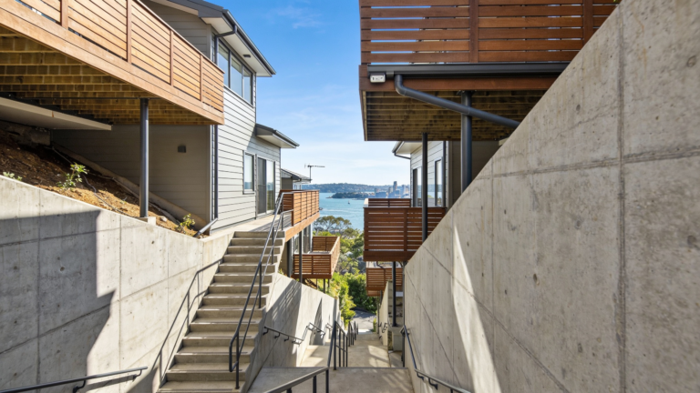 A steep sloping Sydney block with a multi-level home, external stairs and elevated terraces