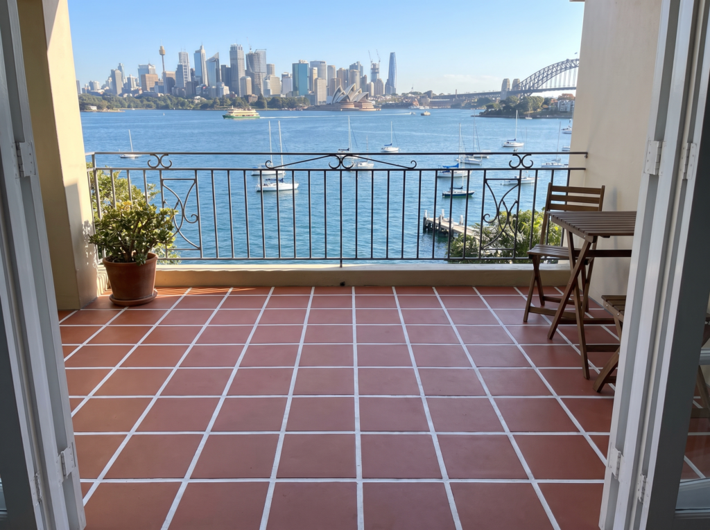 Clean tiled bay-view balcony with bright grout lines in Rose Bay