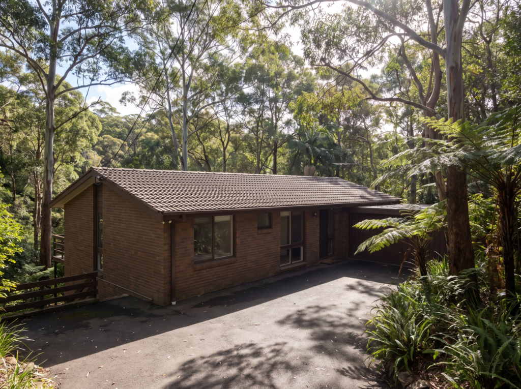 Mid-century brick home beside Lane Cove National Park in West Pymble with clean shaded driveway